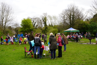 A group of people at our 2024 Wild Child festival, with activities in the background.