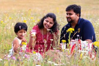 Family picnicking in wildflowers