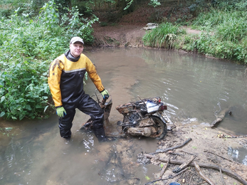 Tom Beasley-Suffolk clearing rubbish (a moped) out of the Painswick Stream
