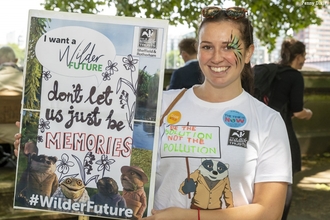 Young women holding a sign protesting for wilder future in london