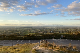 The view from the top of Crickley Hill car park looking over Cheltenham towards Gloucester with low cloud.