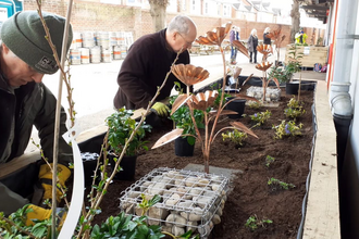 People creating the new rain garden at Kingsholm rugby club, Gloucester 