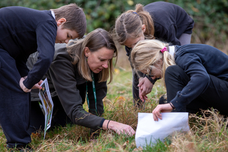 Jennie and a group of children bug hunting