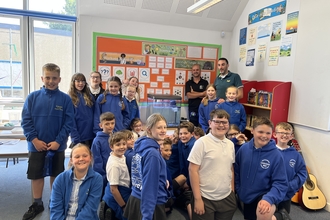 Whitminster primary students next to their tank of eels