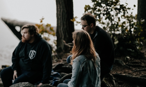 Young people chatting by a lake