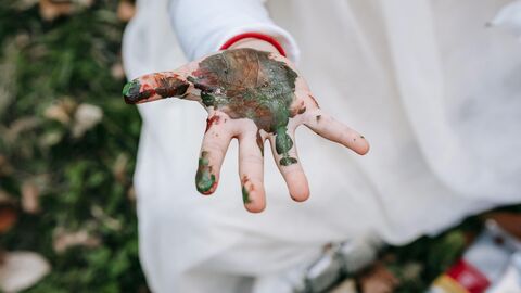 Dirty with mud or paint child's hand