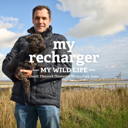 David holding his dog at a wetland