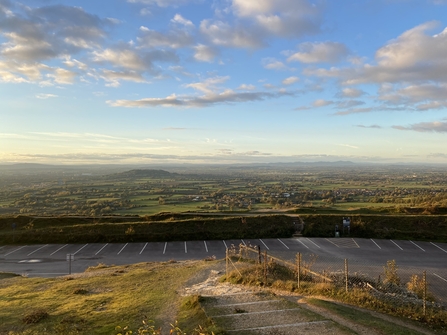 The view from the top of Crickley Hill car park looking over Cheltenham towards Gloucester with low cloud.