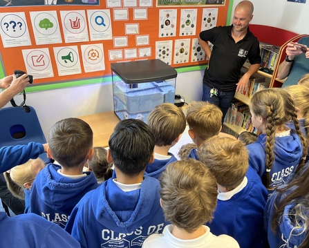 Whitminster primary students next to their tank of eels