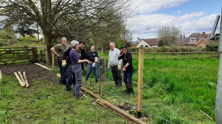 Volunteers laughing after the strength of the post rammers brought it too low!