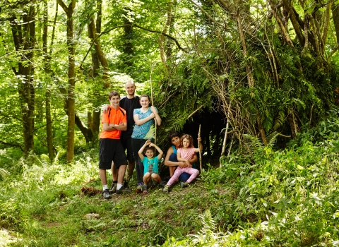 The whole family making a den in the woods