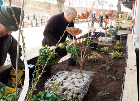 People creating the new rain garden at Kingsholm rugby club, Gloucester 