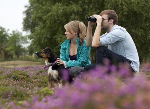 Couple with dog bird-watching